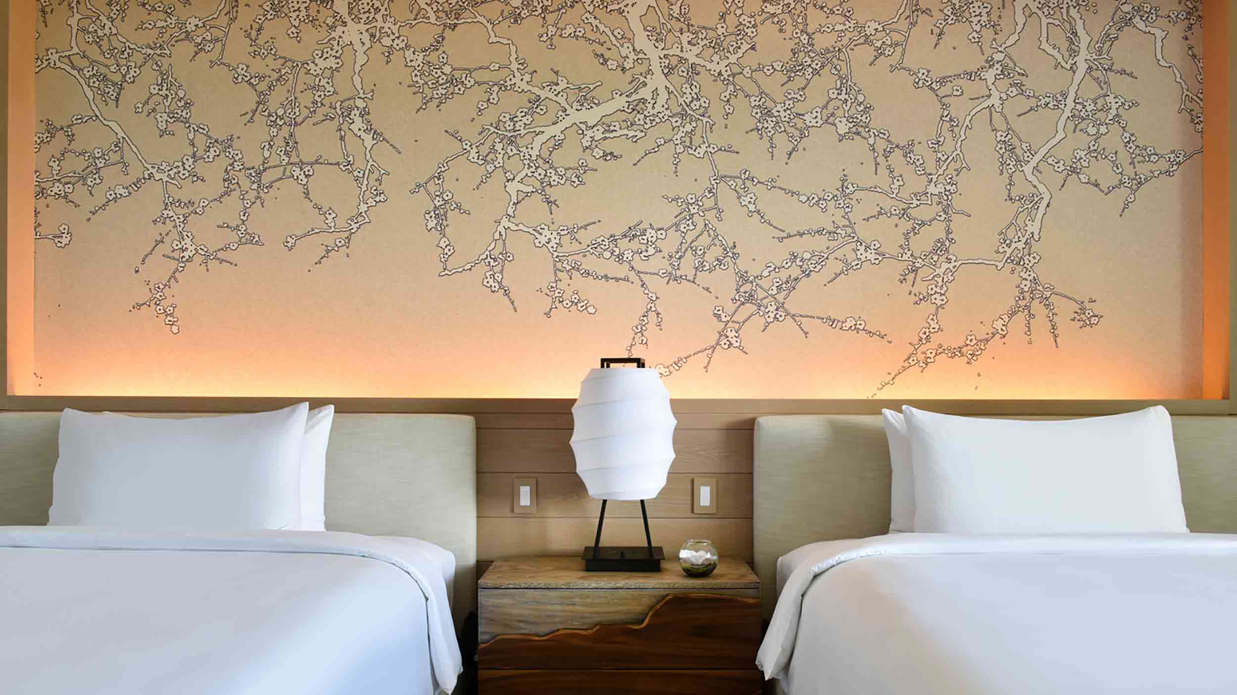 Closeup of double beds and wall art in Nobu Miami Beach Hotel.